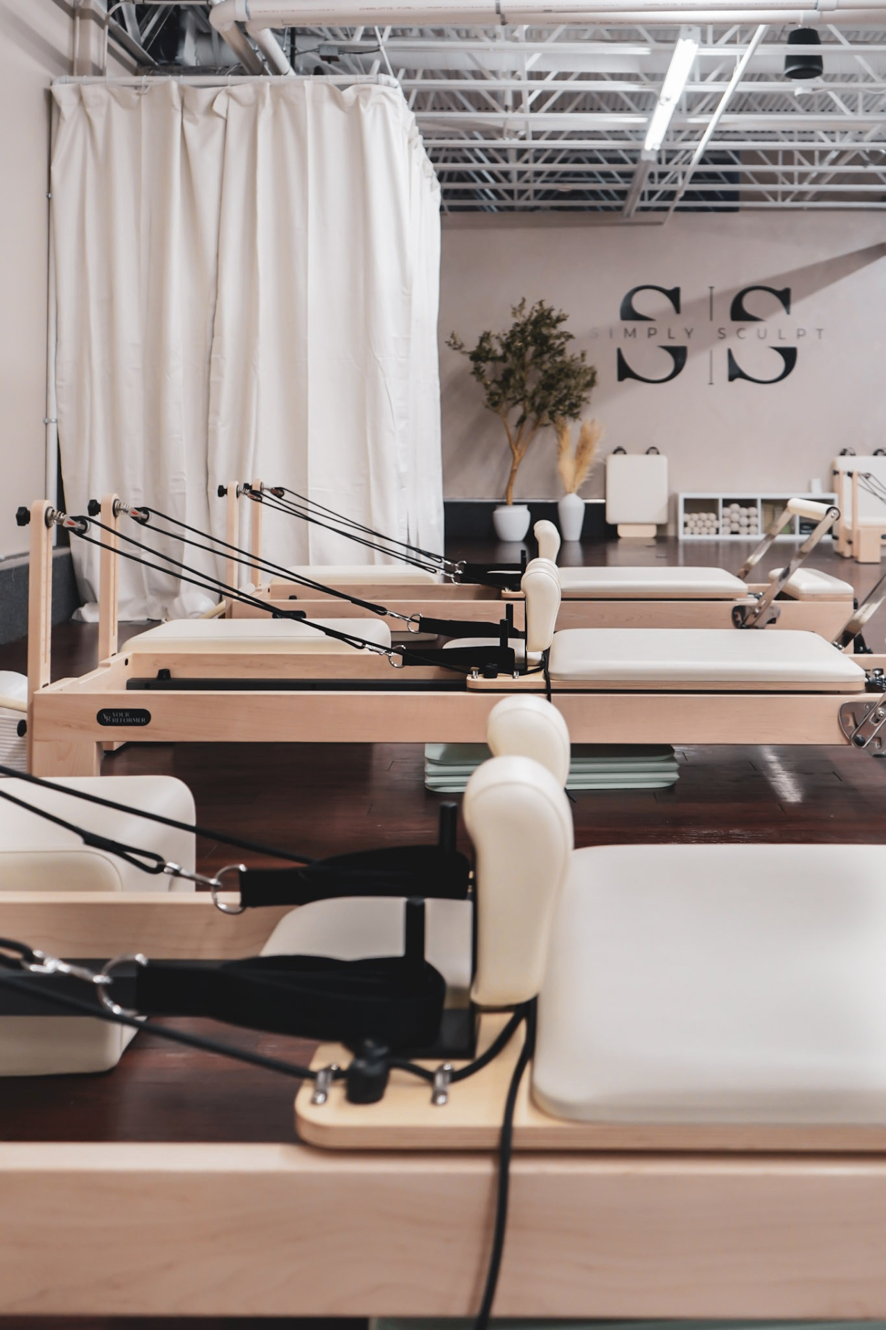Reformer Pilates stations at Simply Sculpt studio in Warwick, RI